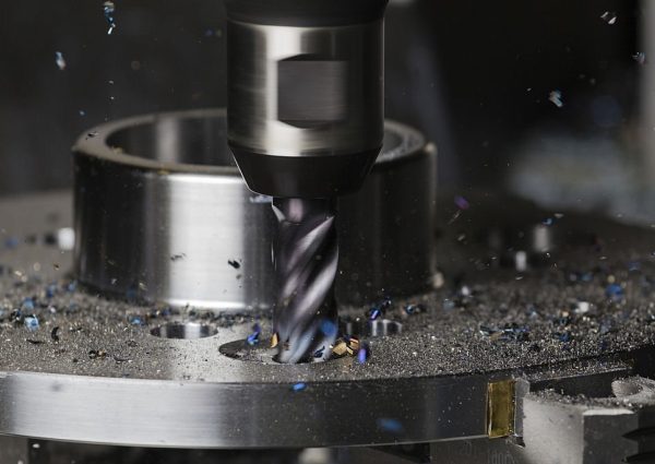 A hole is milled in a flange on a CNC machining center using a carbide endmill