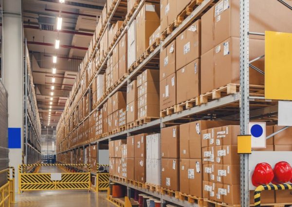 Industrial distribution, composition. Storage with high shelves, cargo boxes on racks. Rows of shelves with boxes at factory.