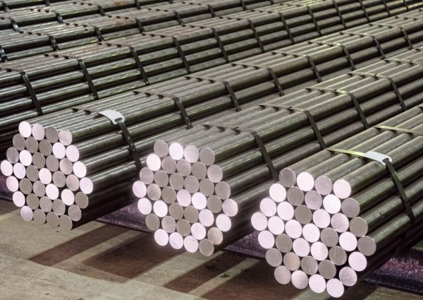 Round steel section rolling profile in stacked. Warehouse of metal products.